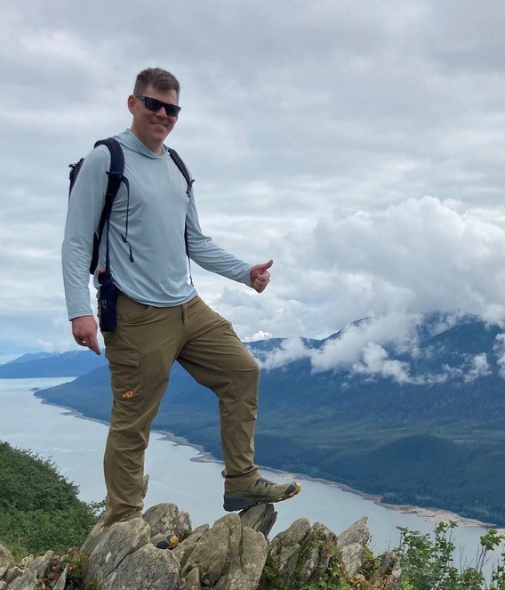 A person standing on a rockDescription automatically generated